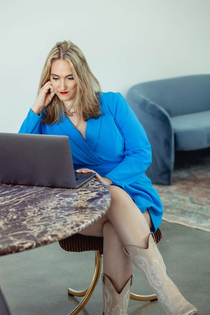 Austin sexual assault lawyer Angelica Cogliano of CMK Defense, PLLC working at her laptop