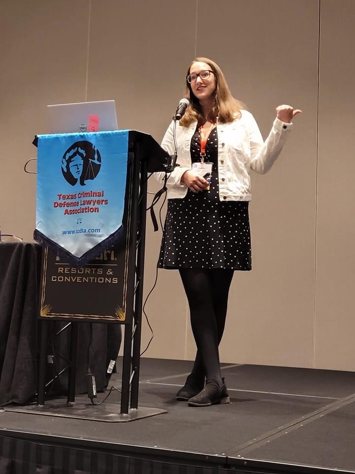 Angelica Cogliano speaking at a Texas Criminal Defense Lawyers Association seminar podium