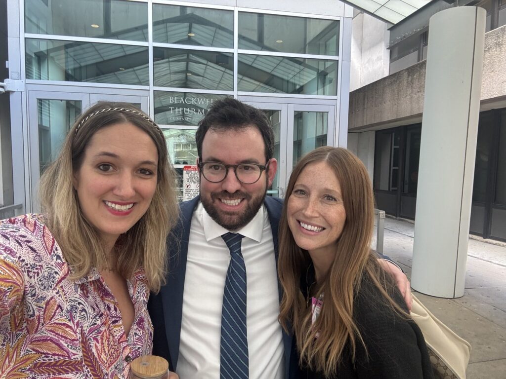 Angelica Cogliano with co-counsel Zachary Bidner and Lauren Sosa smiling outside the Blackwell-Thurman Criminal Justice Center in Austin